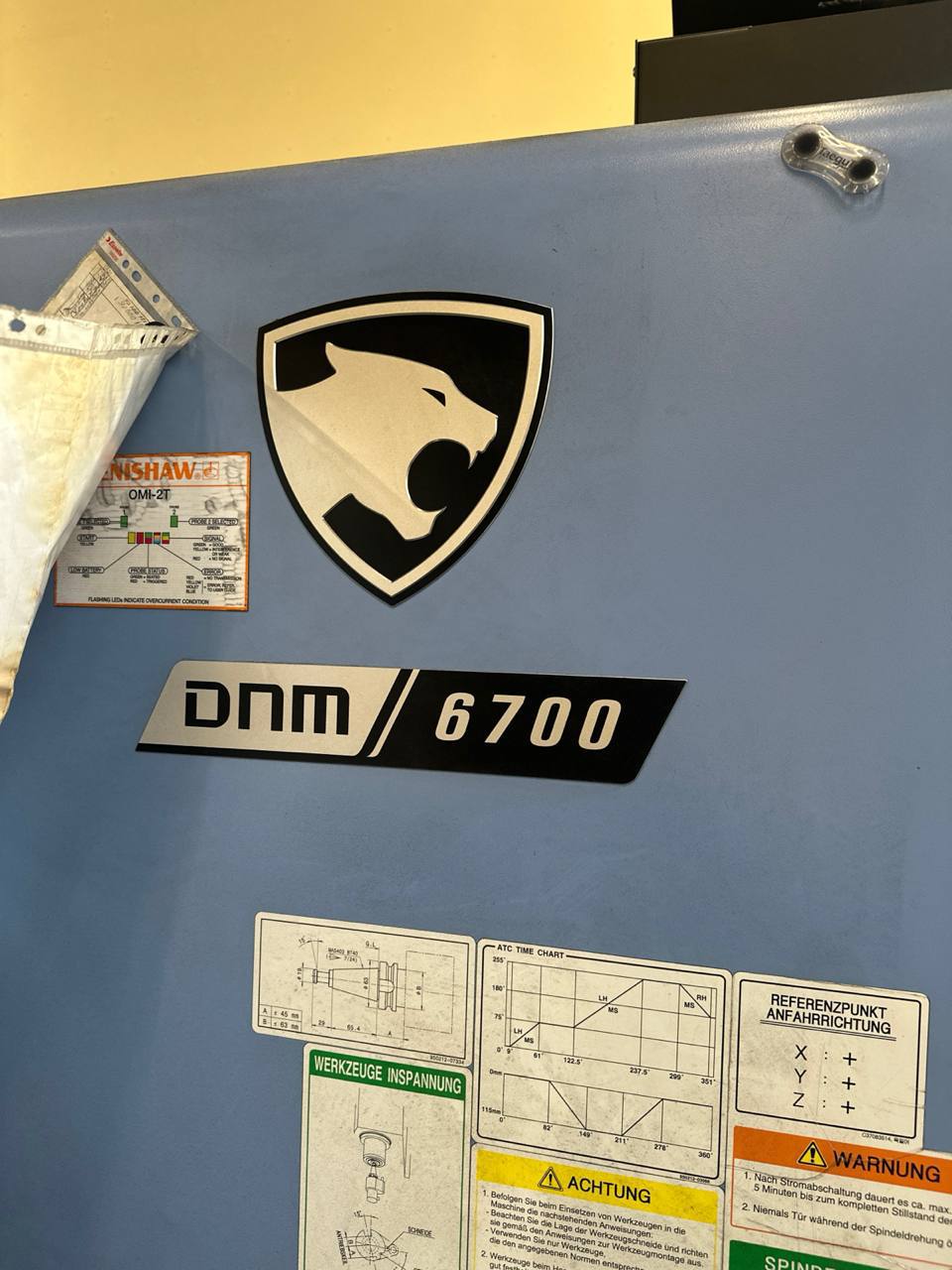 The DNM 6700 nameplate, with the Renishaw OMI-2T probe receiver mounted beside it.